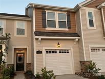 Modern two-story townhome with a neutral color scheme and a two-car garage at 6337 Mallow Crossing Ln, Charlotte, NC 28213