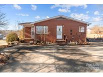 Brick ranch home with a spacious driveway at 700 Snuggs St, Albemarle, NC 28001