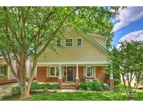 Charming two-story home featuring a brick foundation, neutral siding and a cozy front porch at 741 Mcalway Rd, Charlotte, NC 28211