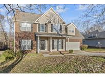 Two-story brick home with a covered porch and attached garage at 10811 Wyndham Pointe Dr, Charlotte, NC 28213