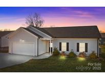 Newly built home with attached garage and landscaped yard at 120 Elmwood Rd, Statesville, NC 28625