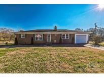 Brick ranch house with attached garage and large yard at 1219 Burke Rd, Shelby, NC 28152