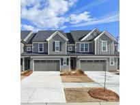 Charming townhome with a two-car garage and gray siding offers modern curb appeal at 23010 Clarabelle Dr, Charlotte, NC 28273