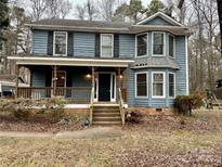 Two-story house featuring a wraparound porch and a spacious yard at 701 Victorian Ln, Monroe, NC 28112