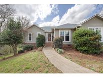 Charming single-story home featuring a well-maintained front yard and inviting entrance at 124 Muirfield Dr, Kings Mountain, NC 28086