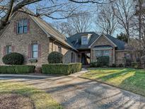 Brick home with landscaped yard and paved driveway at 16506 Barcica Ln, Cornelius, NC 28031