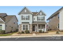 Two-story home with stone accents and a welcoming front porch at 4063 Whittier Ln, Fort Mill, SC 29708