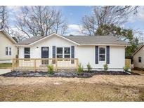 Newly renovated house featuring a white exterior,navy blue shutters, and a small front porch at 433 Greenwood Dr, Charlotte, NC 28217