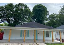 Charming white house with light teal shutters and a gray porch at 507 E Third Ave, Gastonia, NC 28054