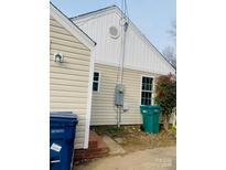 A view of the side of the home, highlighting the siding and backyard access at 640 Mckee St, Albemarle, NC 28001