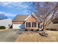 Brick ranch home with attached garage and landscaped yard at 9021 Gander Dr, Charlotte, NC 28277