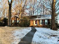 Brick ranch house with a walkway and snowy lawn at 905 Stoney Crest Ct, Mooresville, NC 28115