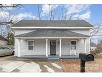 Renovated home with front porch and rocking chair at 92 Saint Charles Ne Ave, Concord, NC 28025