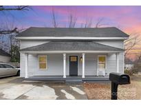 Charming renovated home with front porch and rocking chair at 92 Saint Charles Ne Ave, Concord, NC 28025
