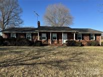 Brick ranch house with covered porch and large yard at 1033 Mocksville Hwy, Statesville, NC 28625