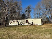 Single-wide manufactured home on a spacious lot with mature trees at 1240 Woodridge Dr, Clover, SC 29710