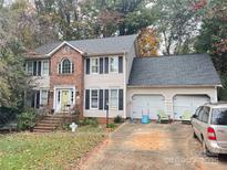 Brick two-story house with attached two-car garage and landscaping at 2328 Londonderry Dr, Gastonia, NC 28056