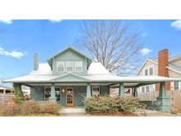 Charming two-story home featuring a covered front porch, updated windows, and mature landscaping at 3317 Ritch Ave, Charlotte, NC 28206