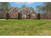 Brick two-story house with a lush green lawn at 7282 James Ct, Denver, NC 28037