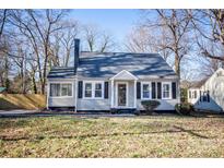 Tan house with gray roof, black shutters, and a small front yard at 751 N Miller Ave, Statesville, NC 28677
