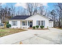 White house with gray shutters, a concrete driveway, and landscaping at 9034 Jaldena Dr, Charlotte, NC 28227