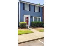 Blue two-story home with shutters, landscaping, and a red front door at 1115 Scaleybark Rd # D, Charlotte, NC 28209