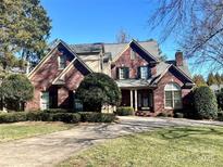 Brick two-story house with a large front yard and driveway at 1180 Asheford Green Ave # 46, Concord, NC 28027