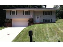 Ranch house with attached garage and well-manicured lawn at 1309 Poplar Cir, Newton, NC 28658