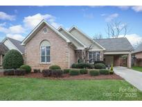 Brick ranch home with landscaped yard and attached garage at 1575 Herlong Ct, Rock Hill, SC 29732