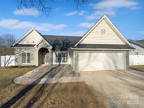 Gray brick house with a two-car garage and stone walkway at 2115 Windy Hill Ln, Monroe, NC 28110