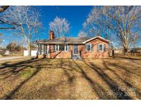 Brick ranch house with a landscaped lawn and mature trees at 2221 Franklin St, Rock Hill, SC 29732