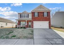 Two-story brick home with a two-car garage and manicured lawn at 2224 Apple Glen Ln, Charlotte, NC 28269