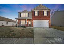 Brick two-story house with a two-car garage and landscaping at 2224 Apple Glen Ln, Charlotte, NC 28269