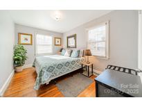 Bright bedroom featuring a comfortable bed and hardwood floors at 2516 Columbus Cir, Charlotte, NC 28208