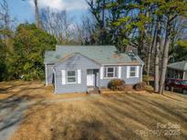 Gray house with white trim and a small yard at 2516 Columbus Cir, Charlotte, NC 28208