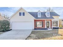 Charming home featuring brick and siding, two-car garage and well maintained lawn at 2820 Rosemeade Dr, Monroe, NC 28110