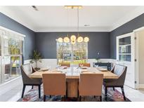 Bright dining room with a large table and modern chandelier at 2943 Tallgrass Blf, Rock Hill, SC 29732