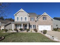 Two-story brick home with a large front yard and landscaping at 5030 Monacan Way, Indian Land, SC 29707