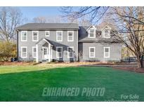 Charming two-story home with a well-maintained green lawn and classic architectural details at 5229 Mt Holly Huntersville Rd, Charlotte, NC 28216