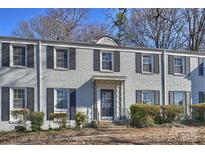 Brick building with gray shutters, a black door, and well-manicured hedges at 533 Wakefield Dr # B, Charlotte, NC 28209