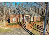 Brick home with landscaping, large windows, and a two-car driveway at 5424 Amanda Ln, Belmont, NC 28012