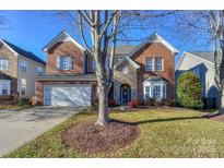 Brick two-story house with a large front yard and attached two-car garage at 626 Lorain Nw Ave, Concord, NC 28027