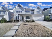 Two-story house with gray siding, stone accents, and a front porch at 925 Gray Hook Dr, Fort Mill, SC 29708