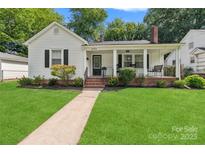 Charming white house with a covered porch and well-maintained lawn at 514 W 8Th Ave, Gastonia, NC 28052