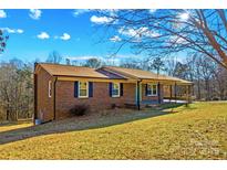 Brick ranch house with a covered porch and a spacious lawn at 539 Bethlehem Rd, Statesville, NC 28677