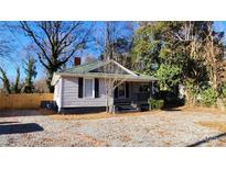 Charming house with gray siding and a gravel driveway at 830 Richard Ave, Kannapolis, NC 28081
