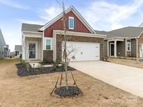 Brick front exterior of charming ranch home with attached garage and landscaping at 1417 Turkey Roost Rd # 69, Fort Mill, SC 29715