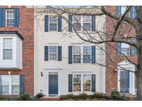 Brick front townhouse with a charming entrance and landscaping at 15712 Kensington Palace Ln, Charlotte, NC 28277