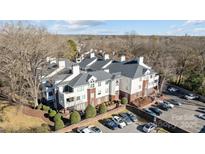 An aerial view of a charming condo building with ample parking at 2719 Selwyn Ave # 7, Charlotte, NC 28209