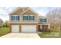Two-story house with stone accents and a two-car garage at 8012 Kennesaw Dr, Gastonia, NC 28056
